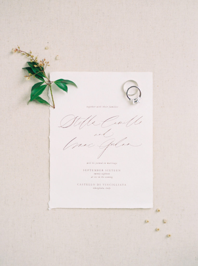 Fine art flat lay with calligraphy from wedding in Italy photographed on film  by Liz Andolina Photography
