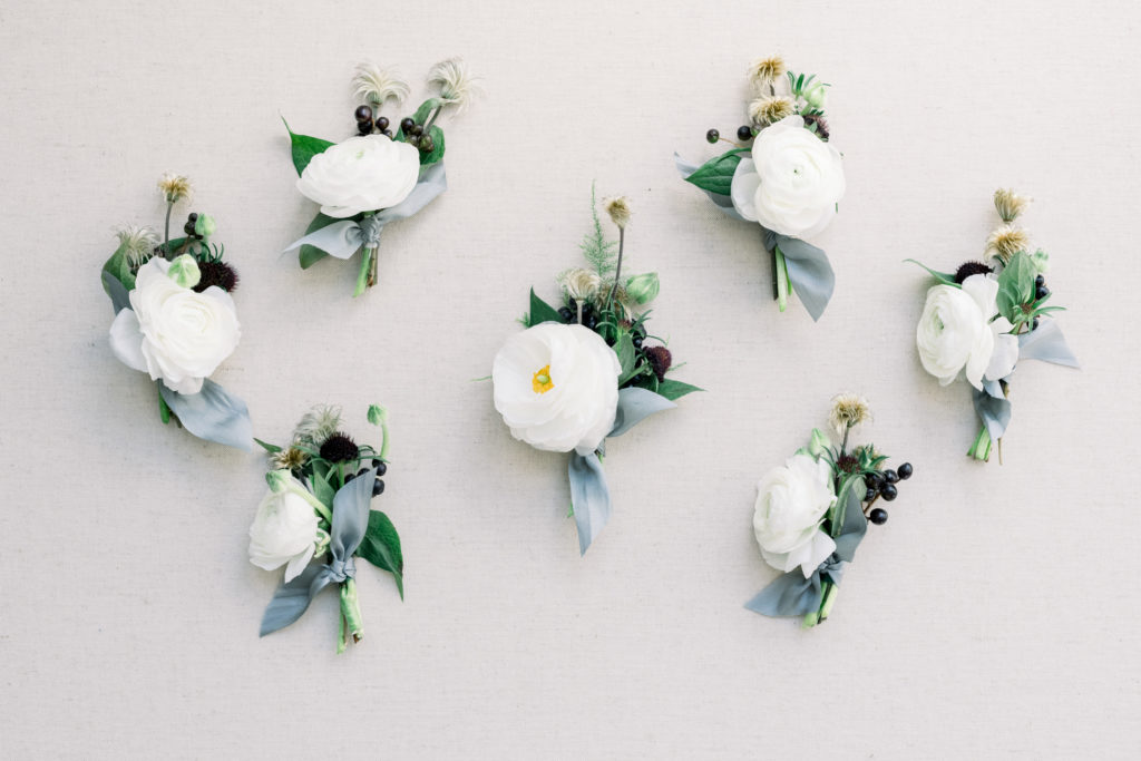 Fine art flat lay of groomsmen boutonnieres photographed by Liz Andolina Photography