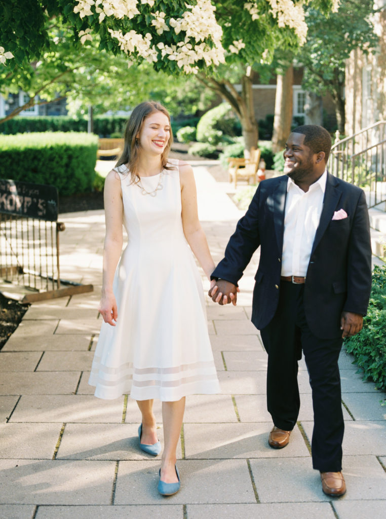 Engaged couple walk through Palmer Square in Princeton