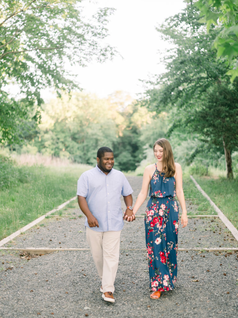 Engaged couple walk through Plainsboro Preserve