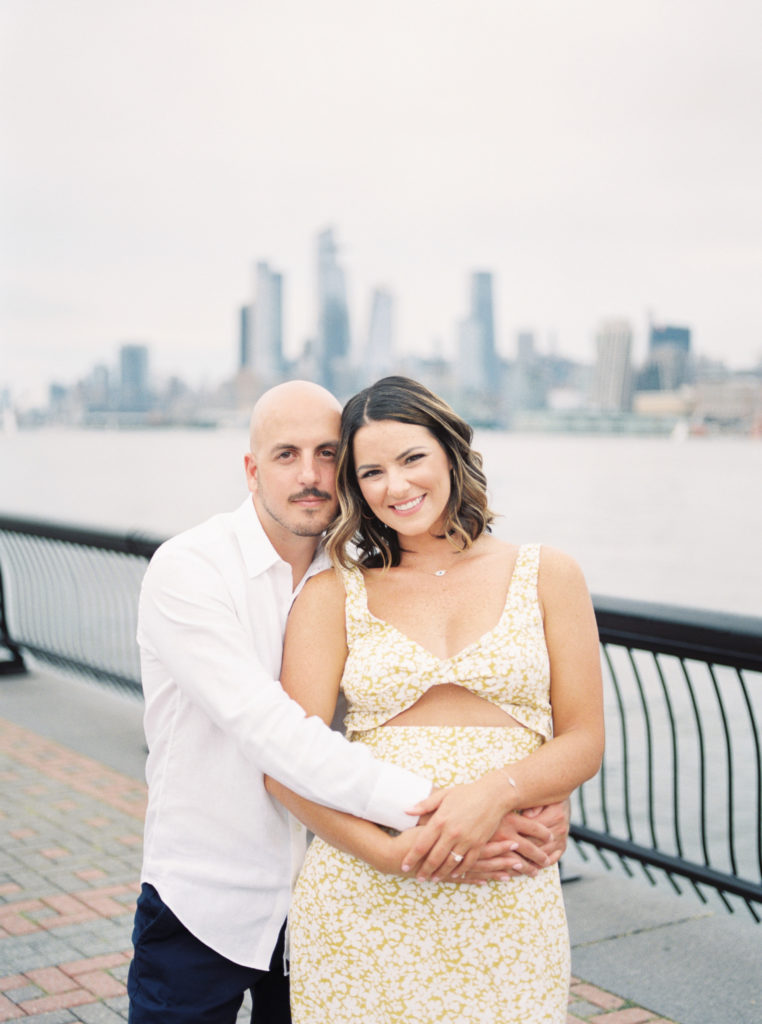 Couple laughing at Pier A Park in Hoboken, New Jersey for their engagement session