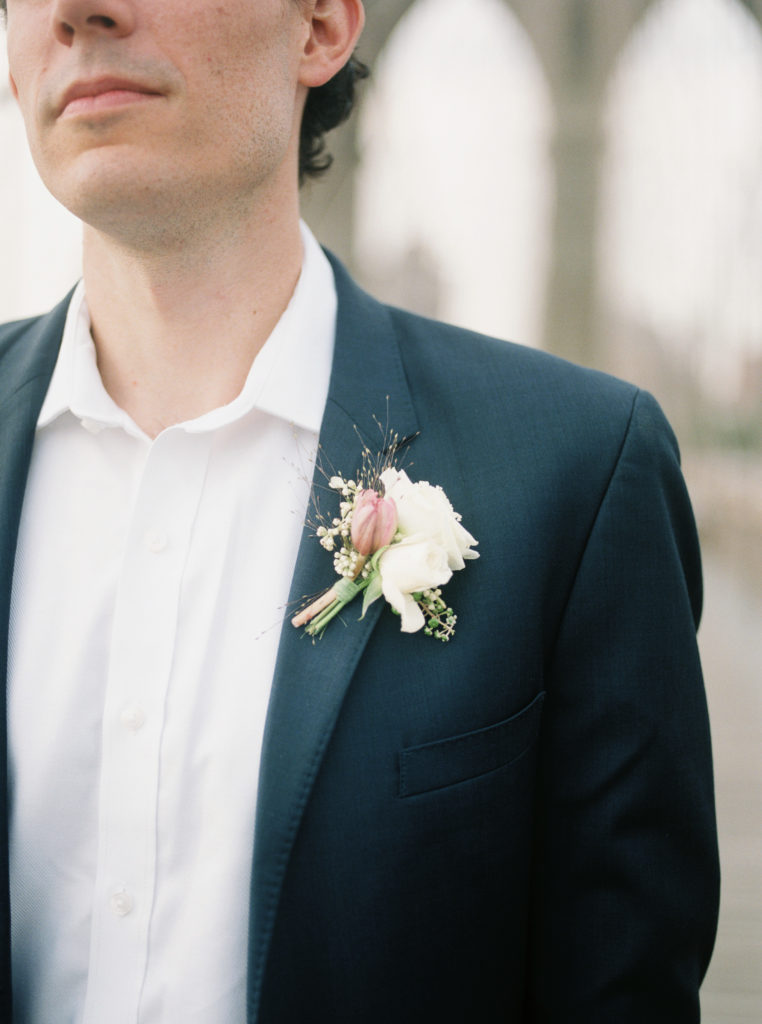 Groom in navy suit with boutonnière 
