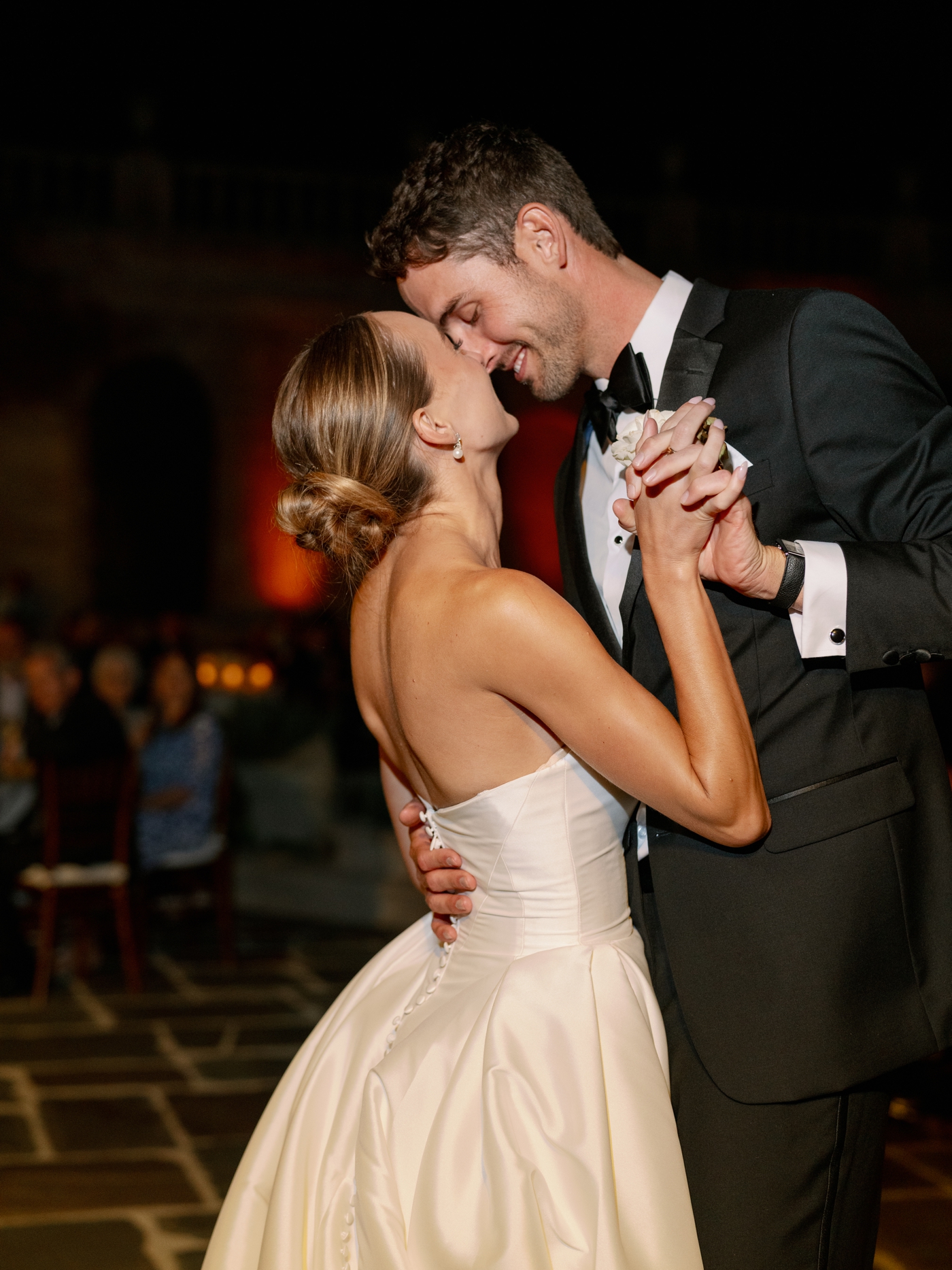 Bride and groom slow dancing with foreheads touching 