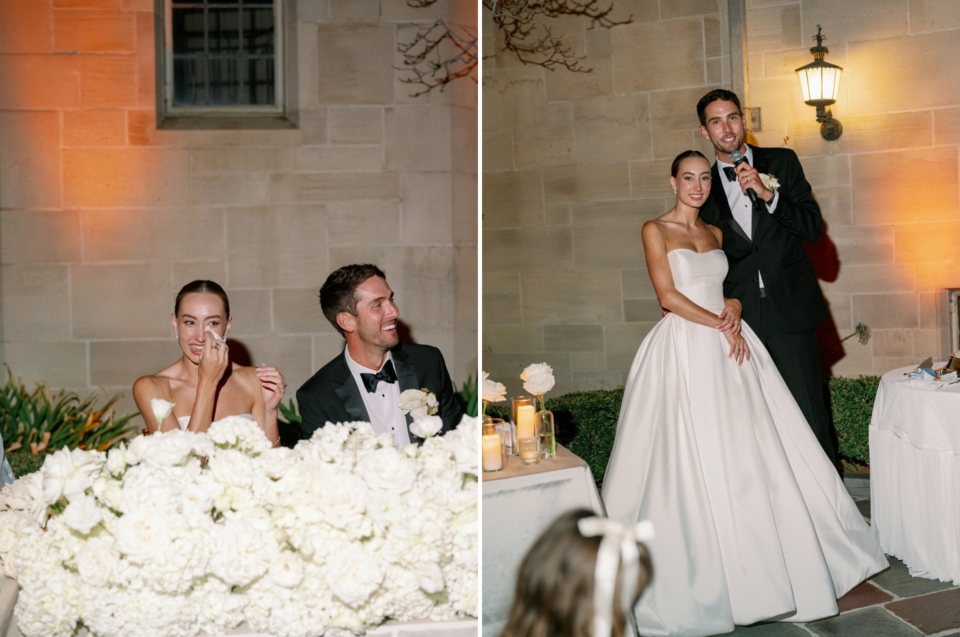 Bride wiping tears sitting next to groom at sweetheart table during wedding speeches