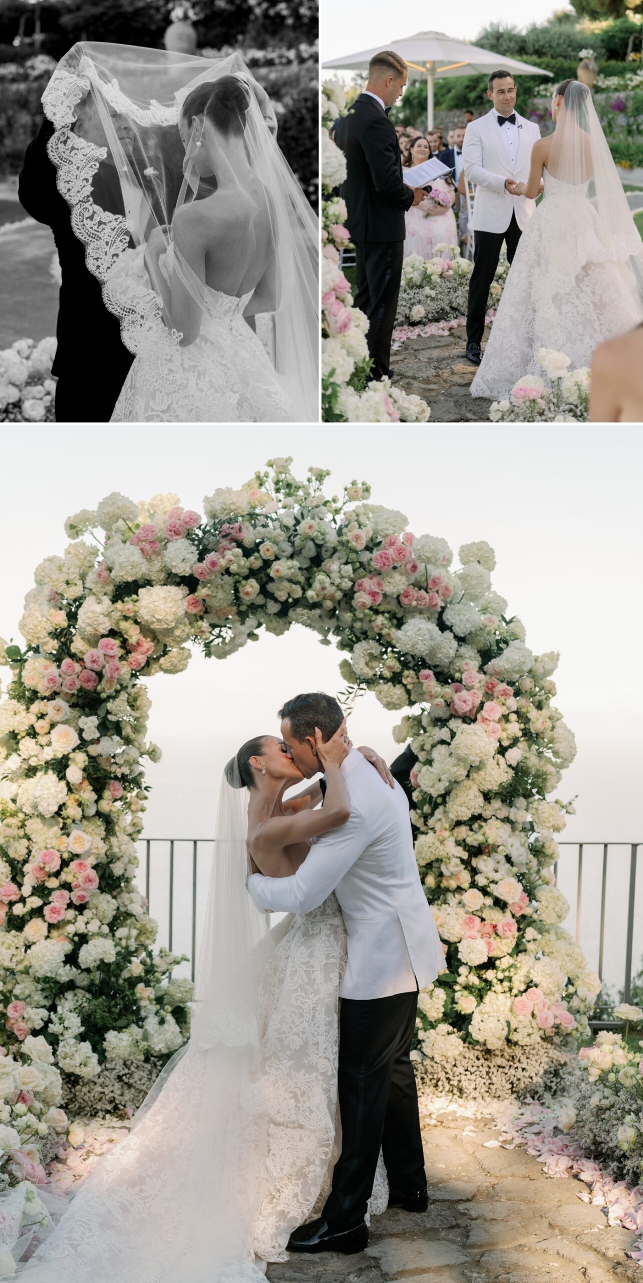 Bride and groom first kiss during wedding ceremony with pink and white floral arch behind them