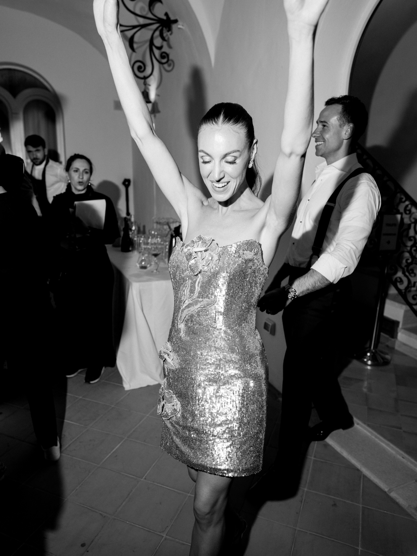 bride wearing sequin mini dress with flower applique to her wedding reception 